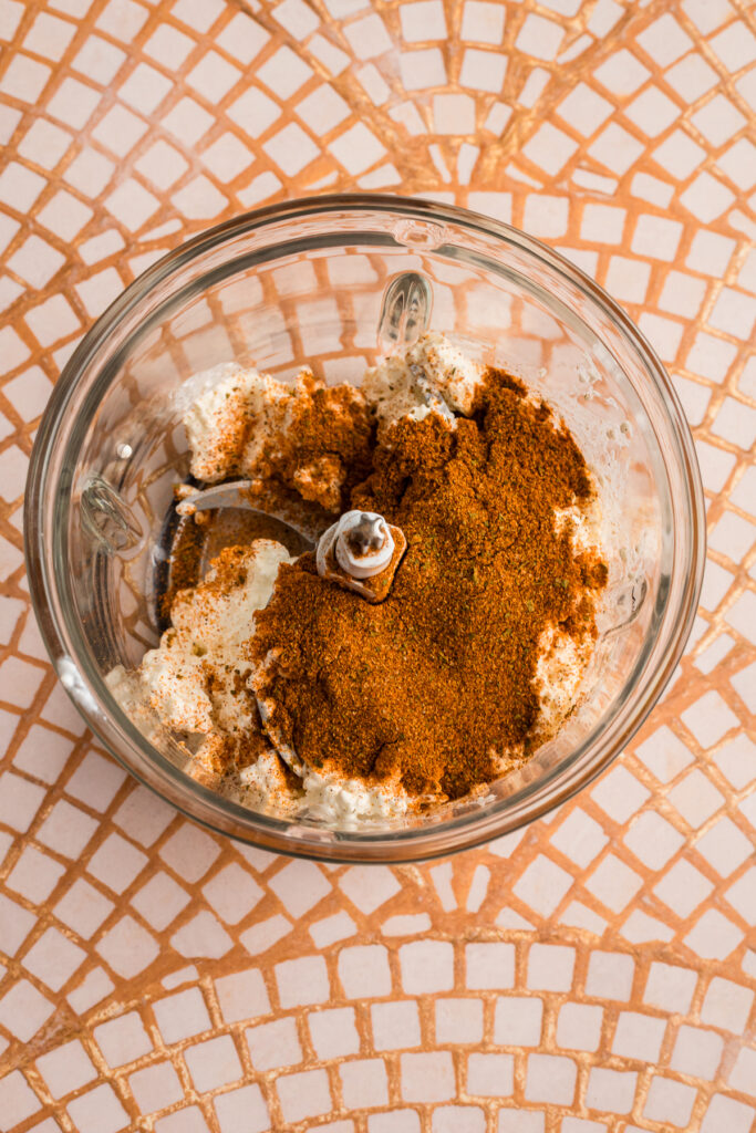 Taco seasoning and cottage cheese in food processor before blending.
