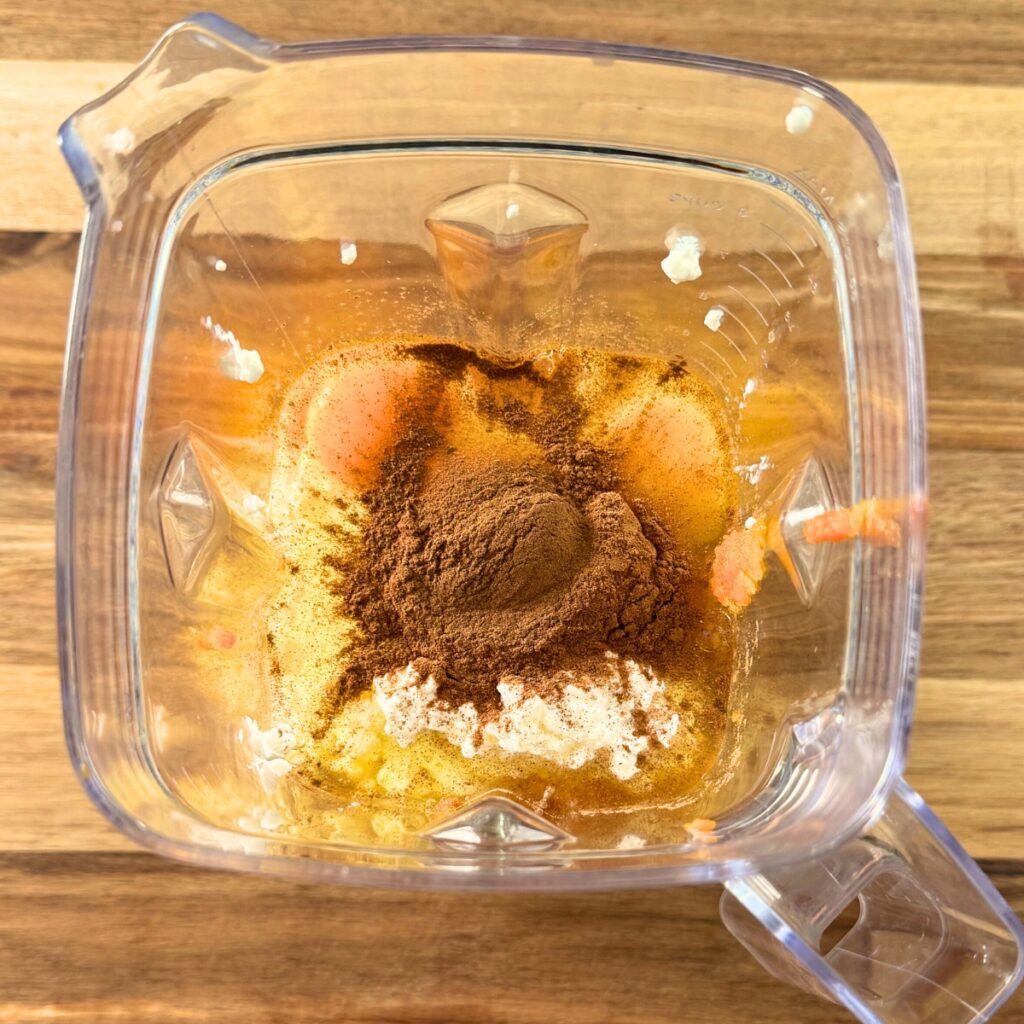 Pumpkin pie ingredients in a blender before blending.