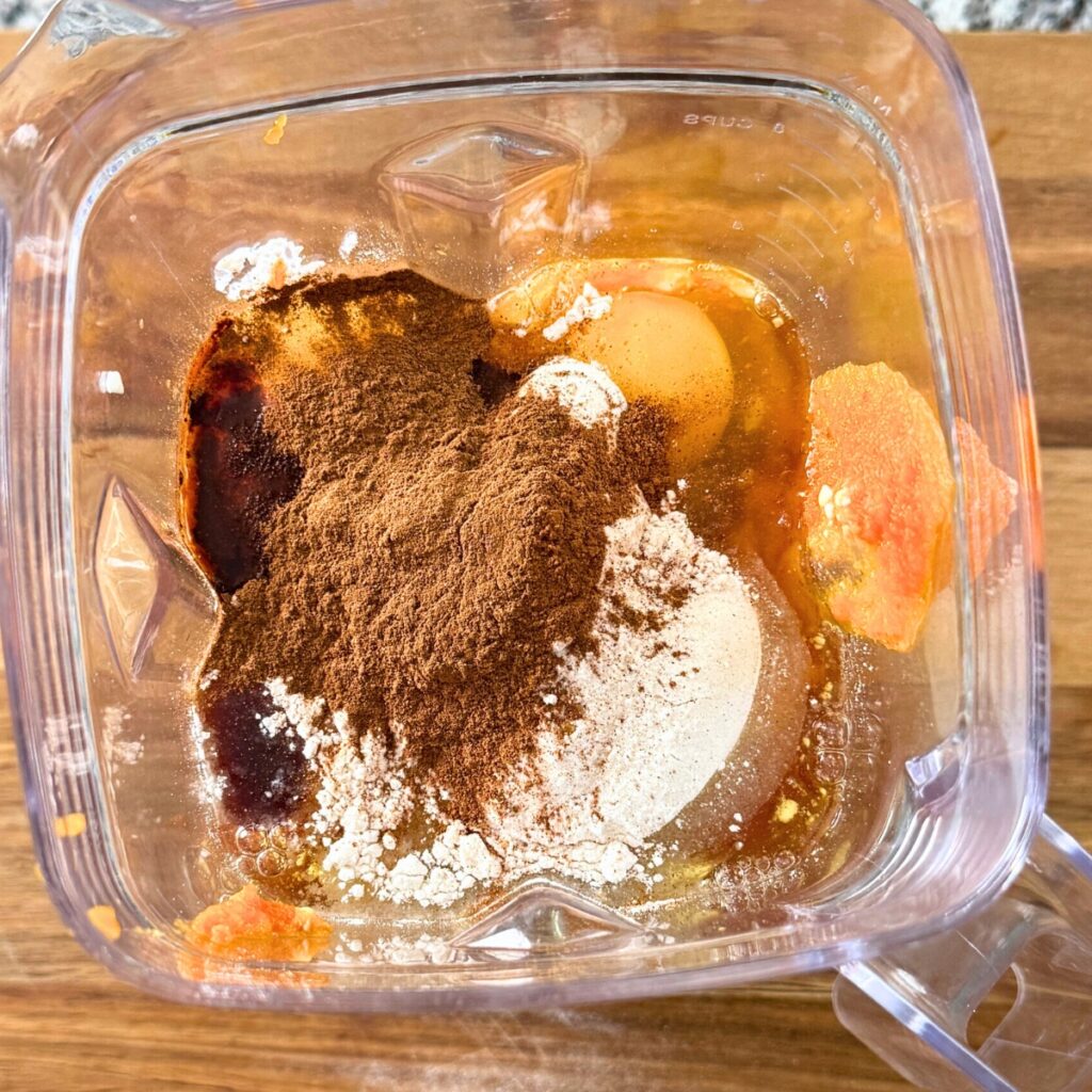 Pumpkin cheesecake mixture in blender before blending.