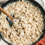 Large cast iron skillet filled with cottage cheese mac and cheese.
