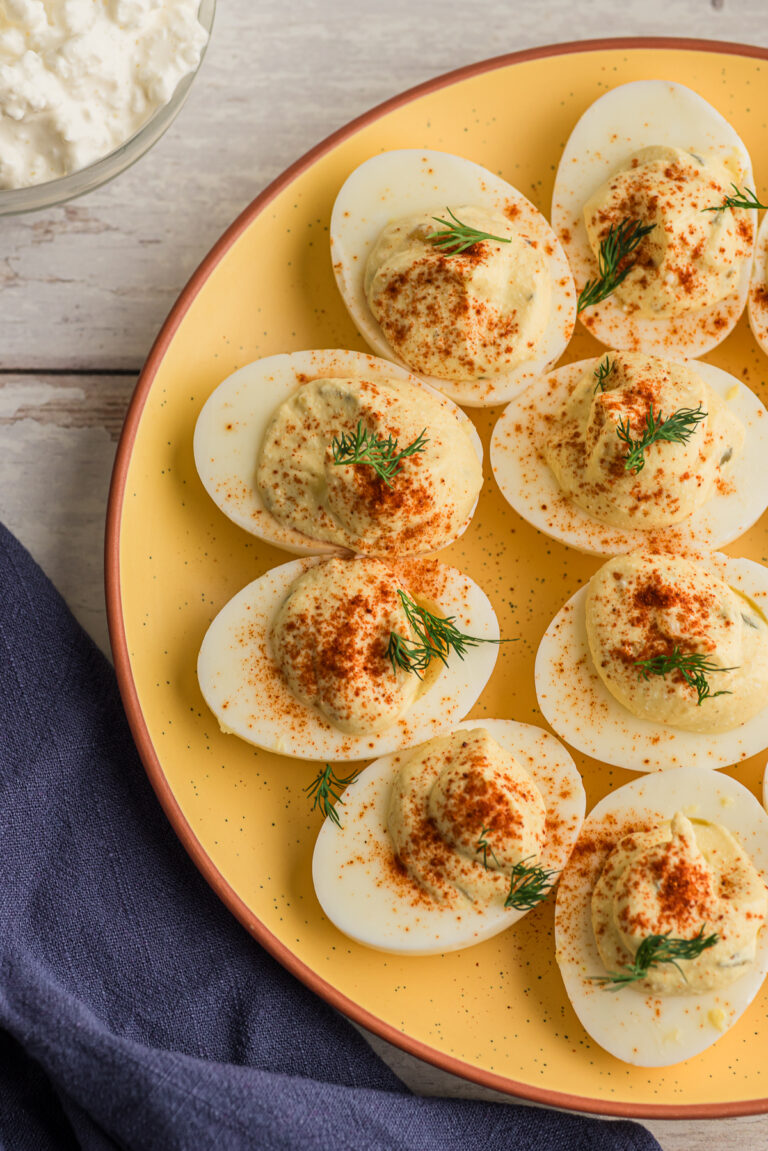 Cottage cheese deviled eggs on a yellow plate.